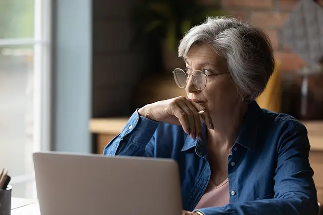 Older woman using a laptop at home