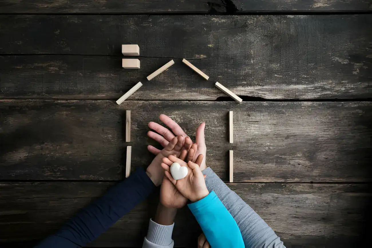 a family of four placing hands on of top of the other