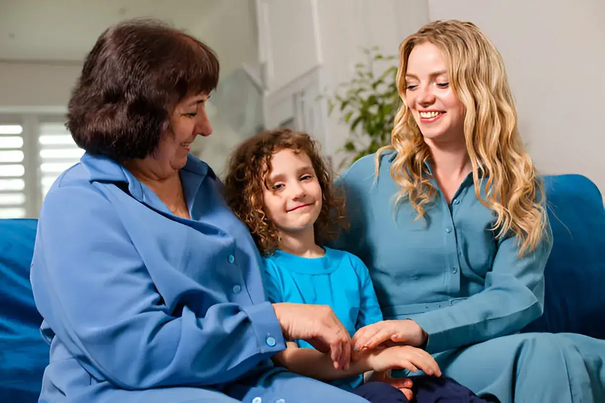 grandma and aunt sitting with child