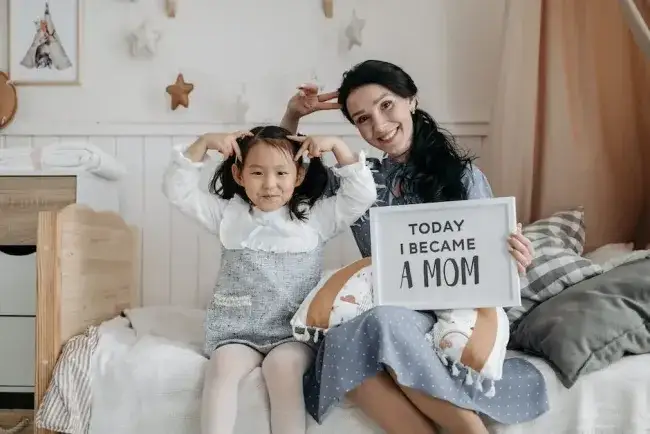 Mom with child holding sign that says Today I am a Mom